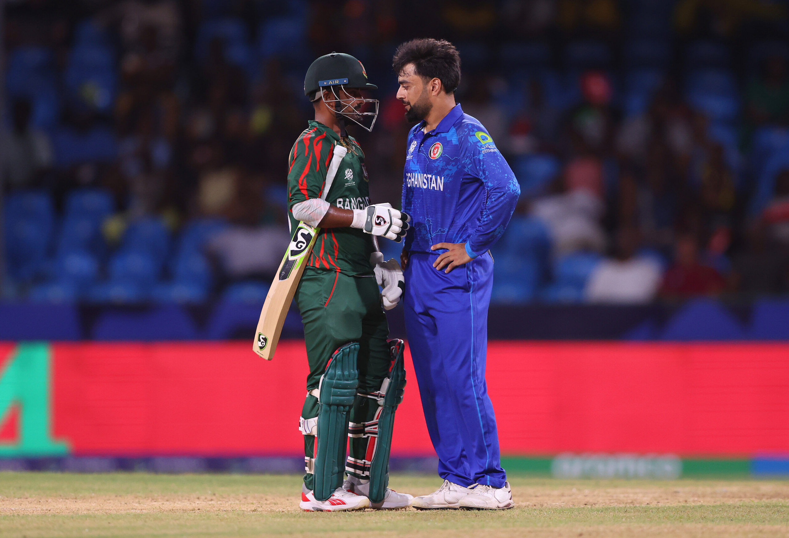 ST VINCENT, SAINT VINCENT AND THE GRENADINES - JUNE 24: Litton Das of Bangladesh and Rashid Khan of Afghanistan interact between wicketsduring the ICC Men's T20 Cricket World Cup West Indies &amp; USA 2024 Super Eight match between Afghanistan and Bangladesh at Arnos Vale Ground on June 24, 2024 in St Vincent, Saint Vincent and The Grenadines. (Photo by Darrian Traynor-ICC/ICC via Getty Images)