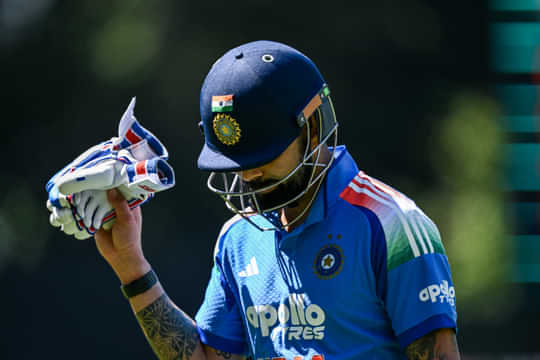Virat Kohli head down gloves up