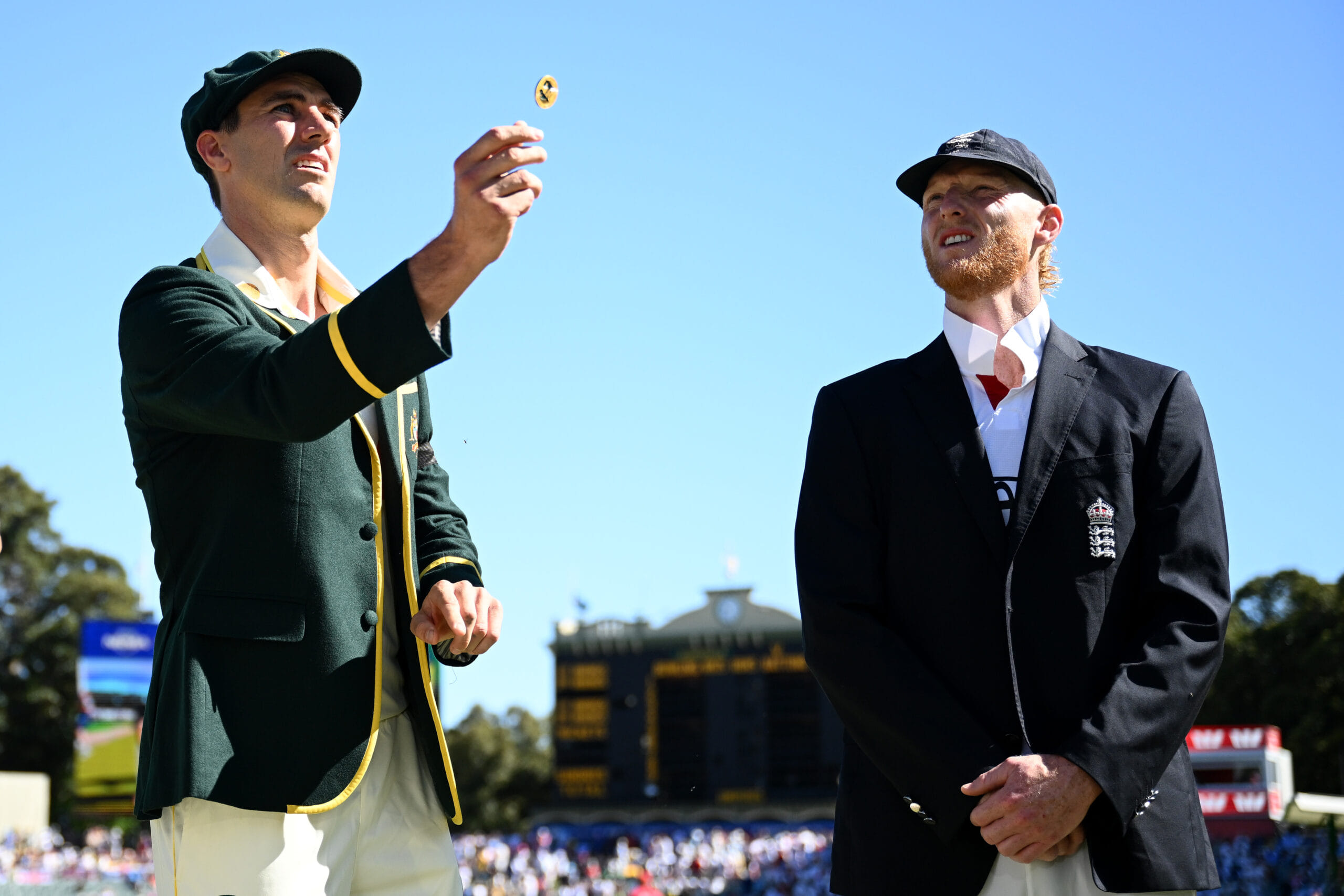 ADELAIDE, AUSTRALIA - DECEMBER 17: Australia captain Pat Cummins tosses the coin alongside England captain Ben Stokes day one of the Third Test Match in the 2025-26 Ashes Series between Australia and England at Adelaide Oval on December 17, 2025 in Adelaide, Australia. (Photo by Gareth Copley/Getty Images)