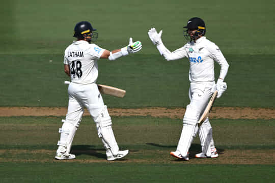 MOUNT MAUNGANUI, NEW ZEALAND - DECEMBER 18: Tom Latham of New Zealand celebrates his century with Devon Conway during day one of the Third Test match in the series between New Zealand and West Indies at Bay Oval on December 18, 2025 in Mount Maunganui, New Zealand. (Photo by Hannah Peters/Getty Images)