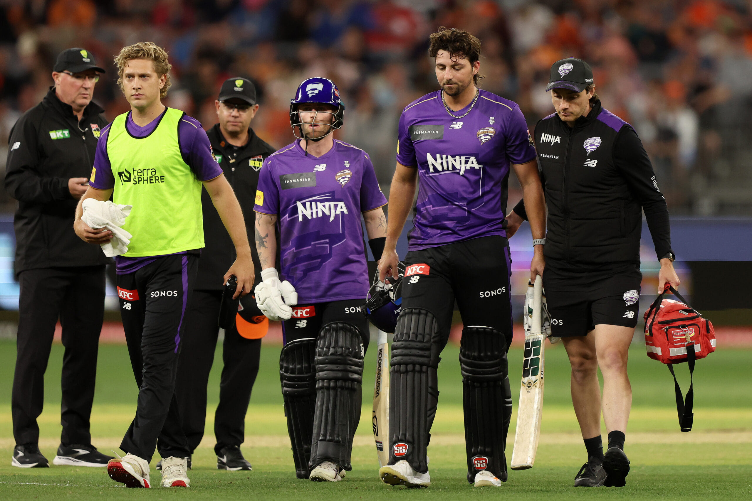 PERTH, AUSTRALIA - DECEMBER 26: Tim David of the Hurricanes leaves the field injured during the BBL match between Perth Scorchers and Hobart Hurricanes at Optus Stadium, on December 26, 2025, in Perth, Australia (Photo by Janelle St Pierre/Getty Images)