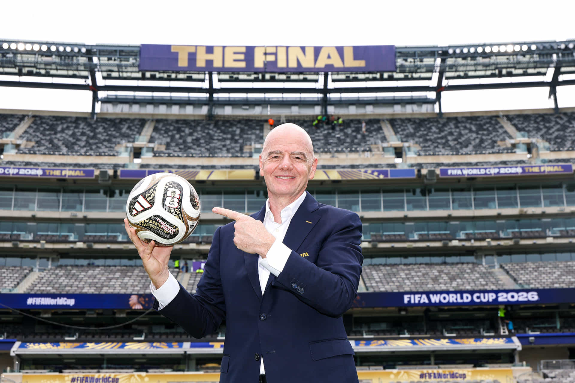 EAST RUTHERFORD, NEW JERSEY - JULY 09: FIFA President Gianni Infantino poses with the TRIONDA FINAL the Official Match Ball for the semi-finals, bronze final and final during his visit to the New York New Jersey Stadium on July 09, 2026 in East Rutherford, New Jersey. (Photo by Dustin Satloff - FIFA/FIFA via Getty Images)